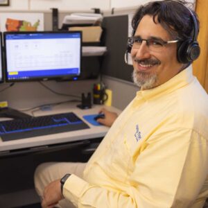 customer service representative updating a property manager's handytrac system during a property management transition